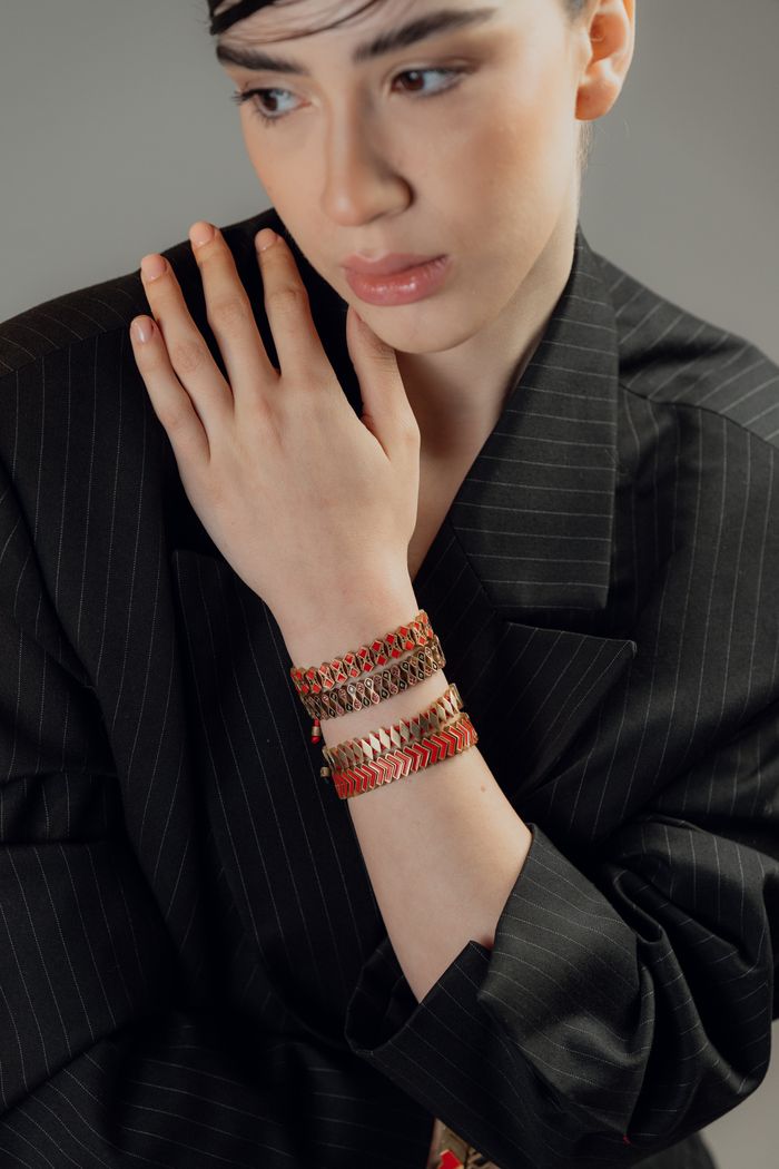 Stylish adult woman wearing intricate woven bracelets, showcasing fashion and elegance.