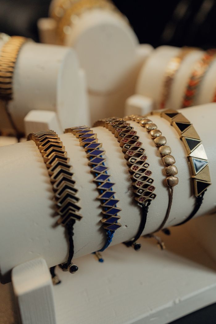 Chic and trendy bracelets showcased elegantly on a jewelry stand in warm light.